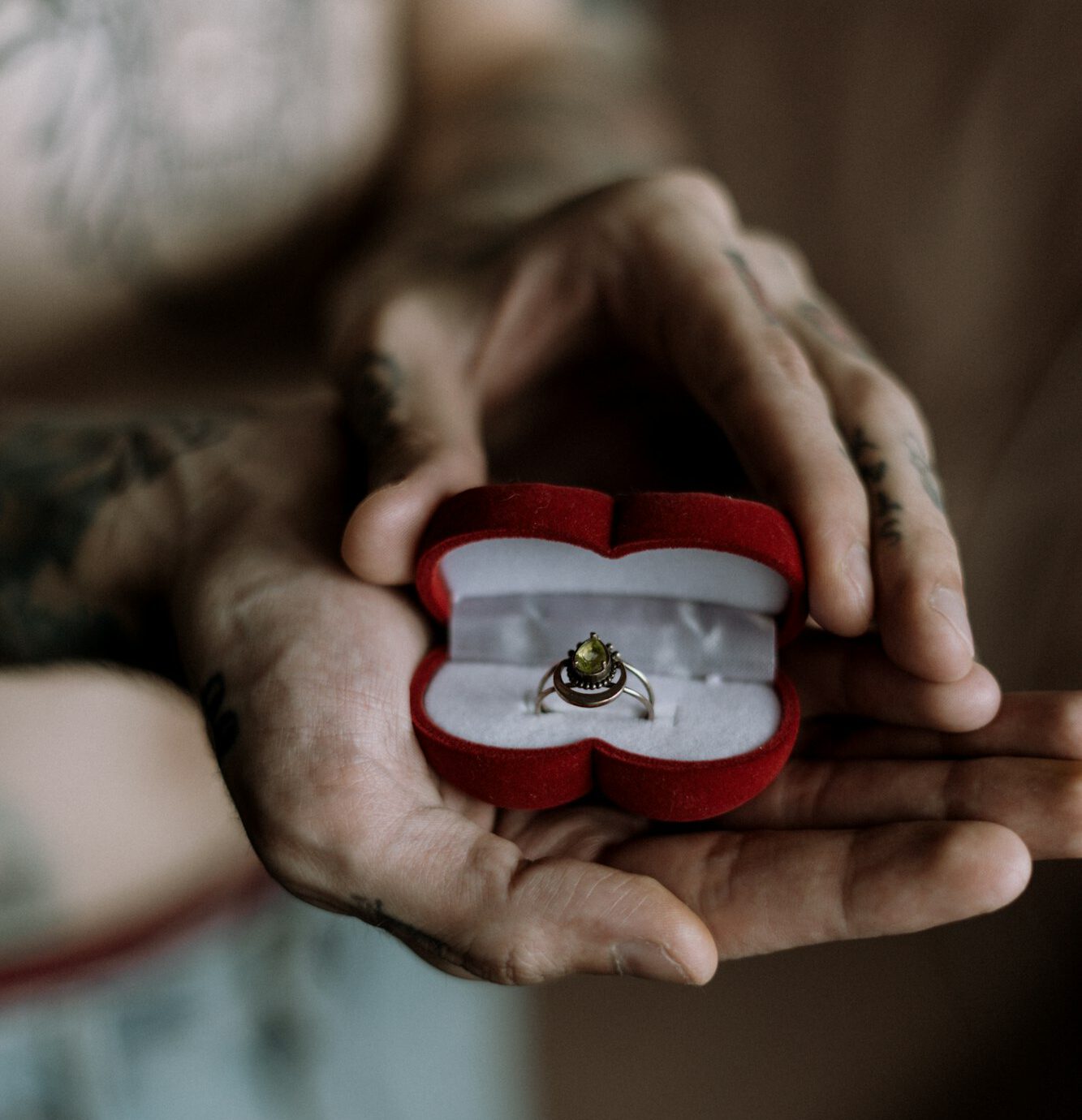 Proposal. Engagement Ring. Wedding celebration. Man holding an engagement ring